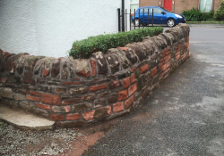 Wall taken down and rebuilt including new stones where needed